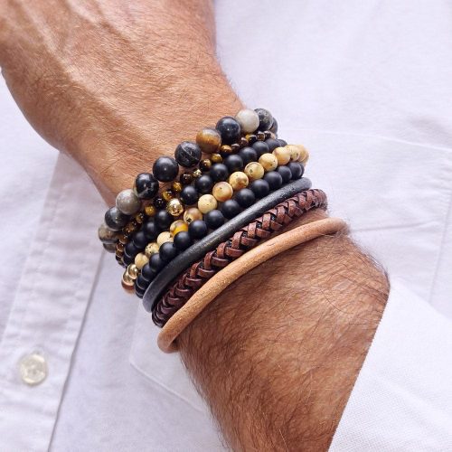 2 men s black onyx beaded bracelets stacked w 2 tiger s eye beaded bracelets w 14k gold beads w agate bead bracelet and 3 leather bracelets white shirt