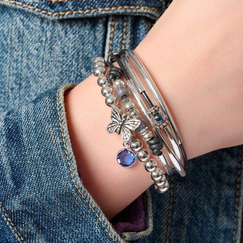 mini asha silver bracelet w butterfly charm next to Zenzi silver bead bracelet denim