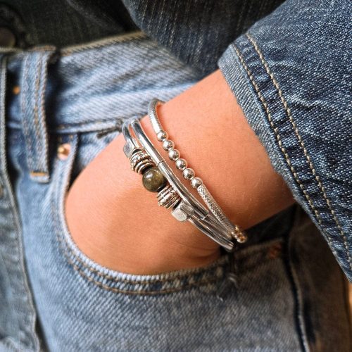 sofi silver and leather bracelet w golden obsidian next to Lim sterling silver beaded stretch bracelet denim